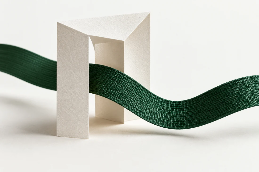 Paper and green ribbon illustrating clinical teams with a reviewed handoff.