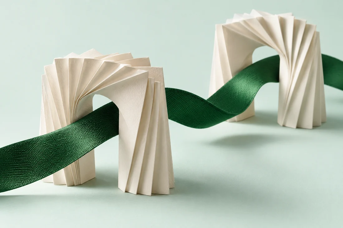 Paper and green ribbon illustrating practice managers with a reviewed handoff.