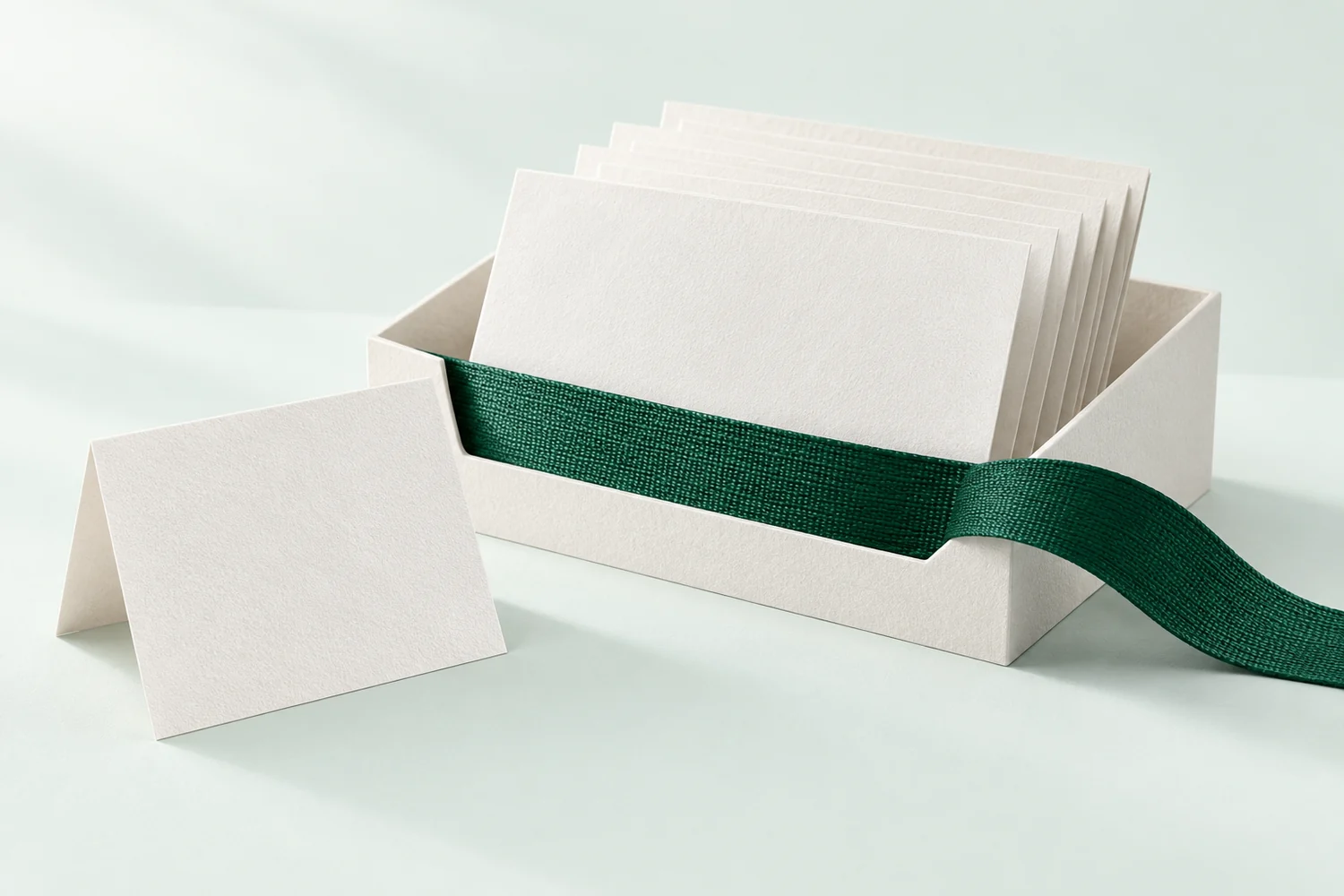 Paper and green ribbon illustrating pre-visit planning with a reviewed handoff.